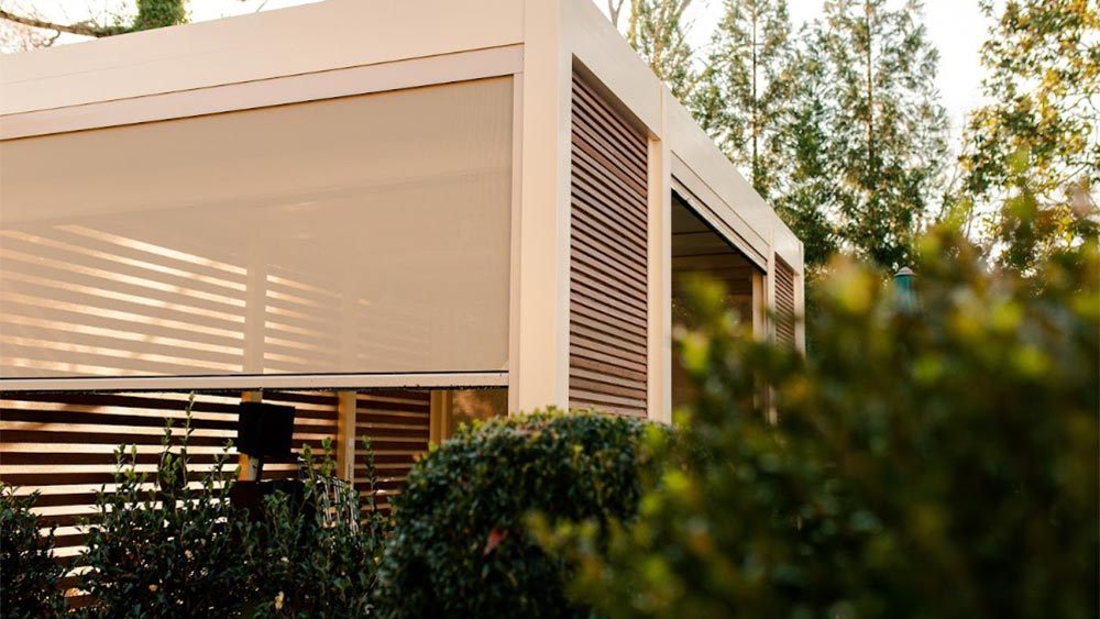 Motorized privacy screens on a pergola.